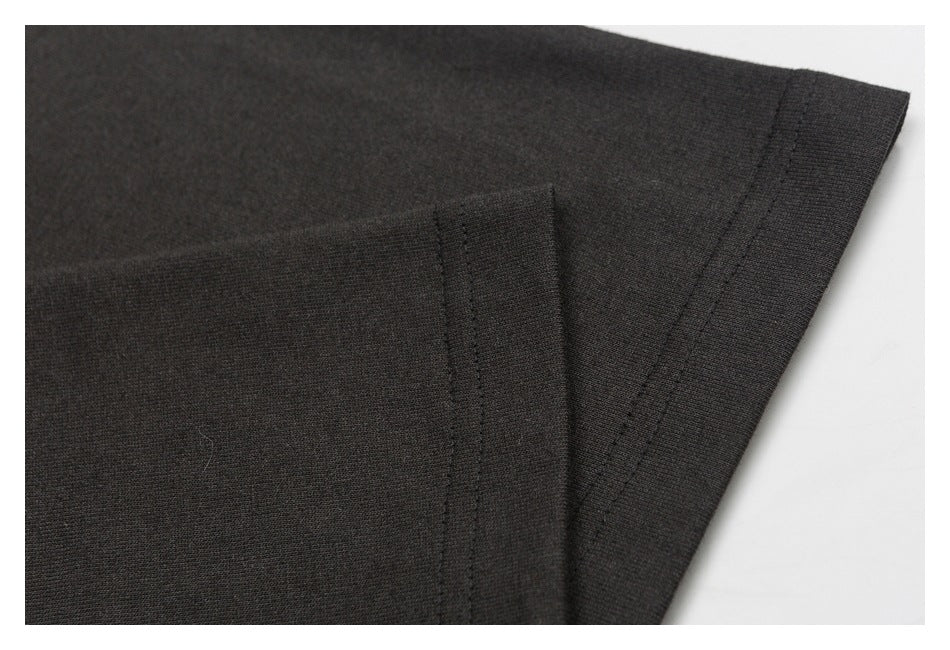Close-up of a black T-shirt sleeve edge and double-stitched hem.