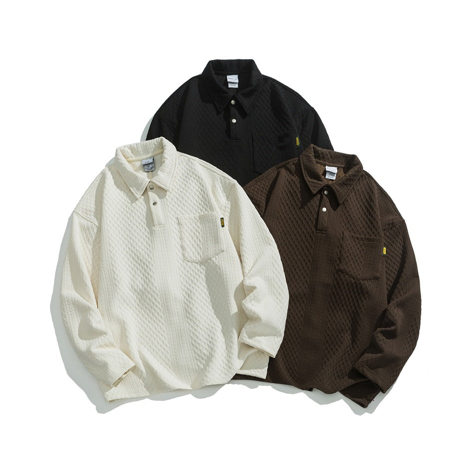 Cream, dark brown, and black long-sleeve collared shirts arranged together, each with a chest pocket and snap placket.