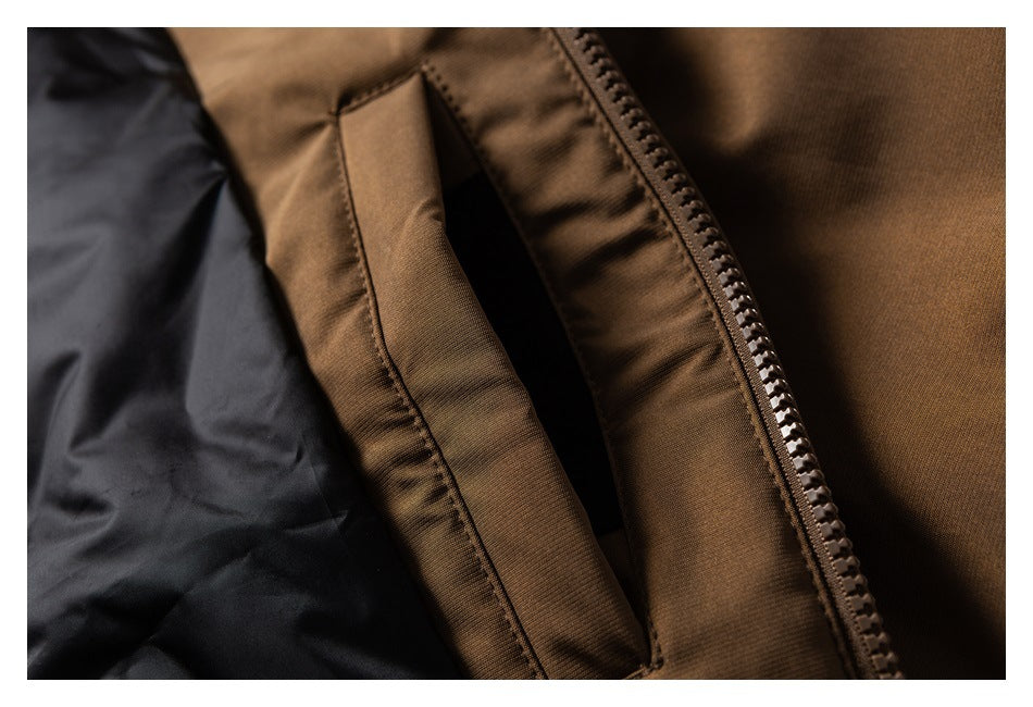 Close-up of a brown jacket's zippered pocket and black lining.