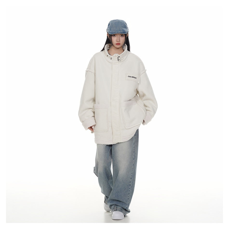 Full-length view of a model in the oversized beige jacket with wide-leg jeans, denim cap and white sneakers