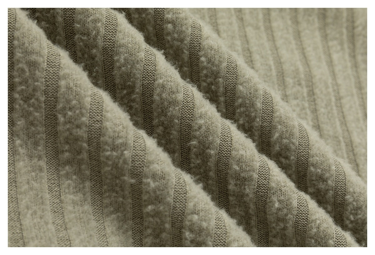Extreme close-up of beige fabric with raised fuzzy vertical stripes and contrasting woven bands.