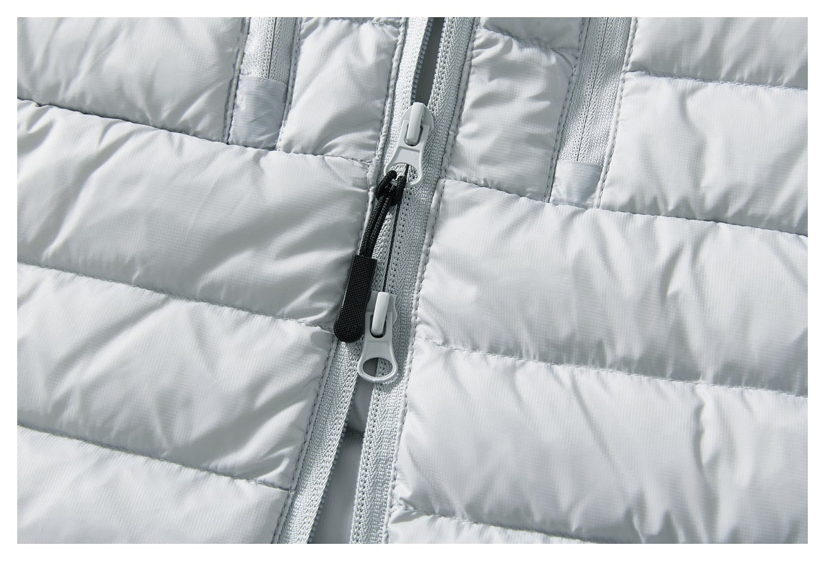 Close-up of a light gray puffer jacket with horizontal quilting and a center zipper with two pulls.