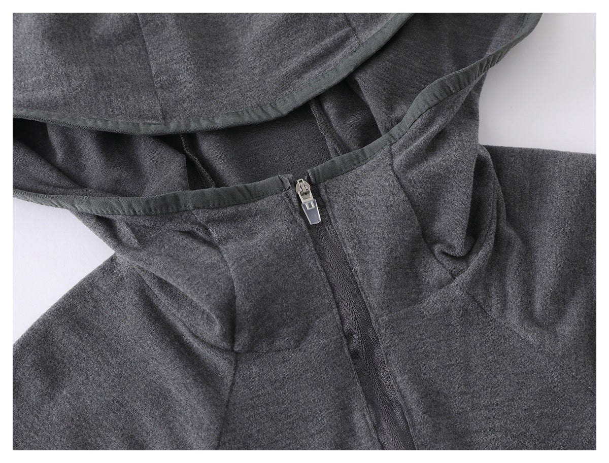 Close-up of the charcoal gray hoodie's hood opening, bound edge, and zipper pull.