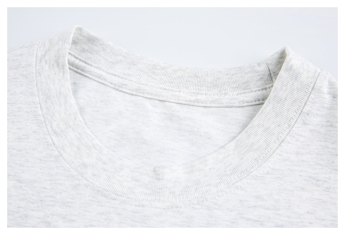 Close-up of a light gray heather T-shirt’s ribbed crew neckline and stitching.