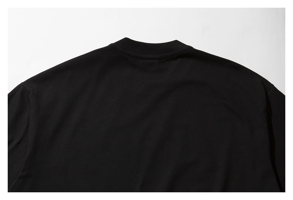 Back view of a plain black short-sleeve crew-neck T-shirt laid flat against a light background.