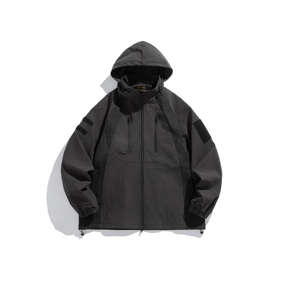 Black hooded zip jacket with chest zip pockets, sleeve patches, elastic cuffs and drawcord hem, flat front view