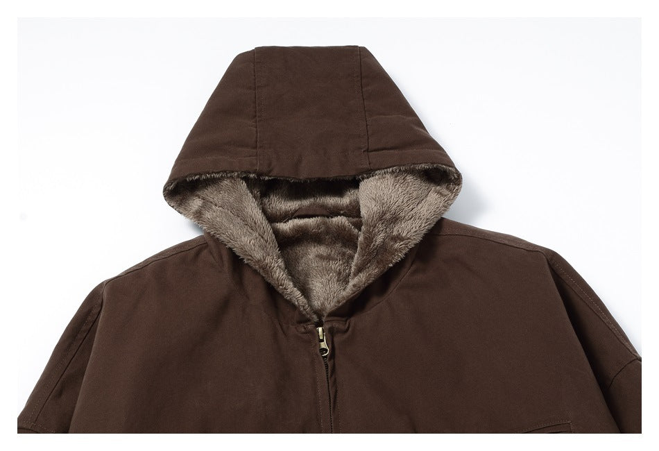 Close-up of the jacket’s brown hood, showing its soft taupe lining and front zipper.