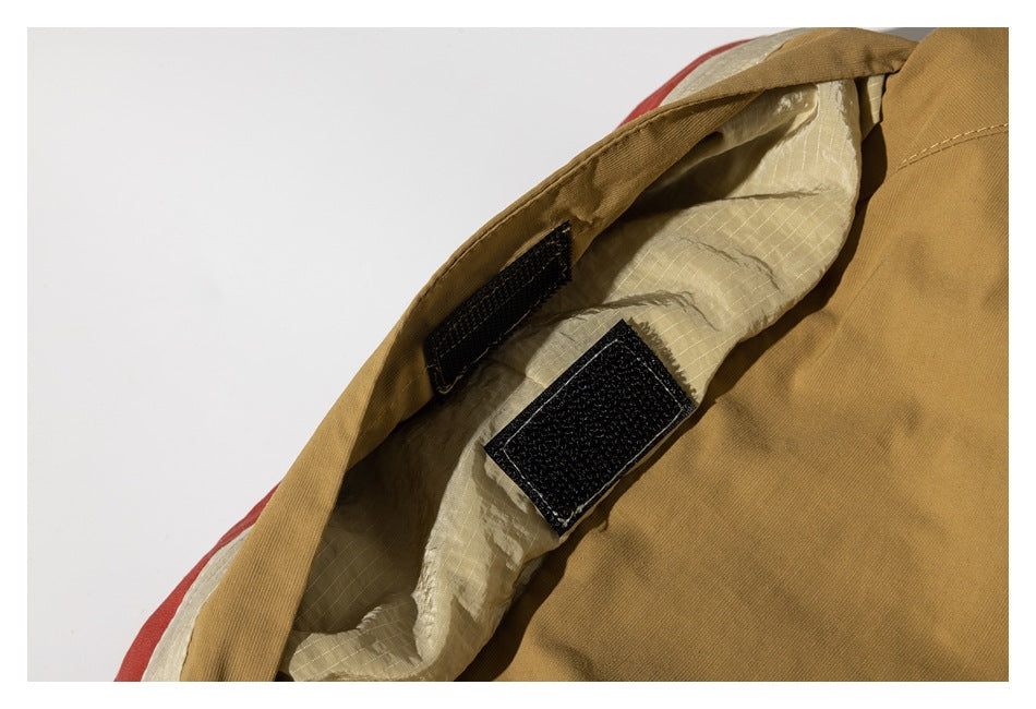 Close-up of a tan garment with beige lining and black hook-and-loop fastening tabs.