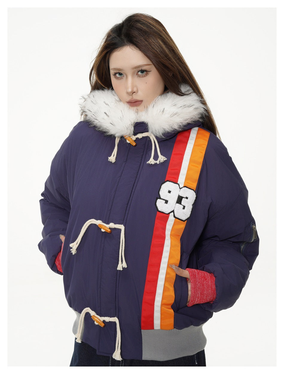 Model wearing a hooded jacket with white fluffy trim, toggle ropes, red-white-orange stripe and 93 patch, hands in pockets