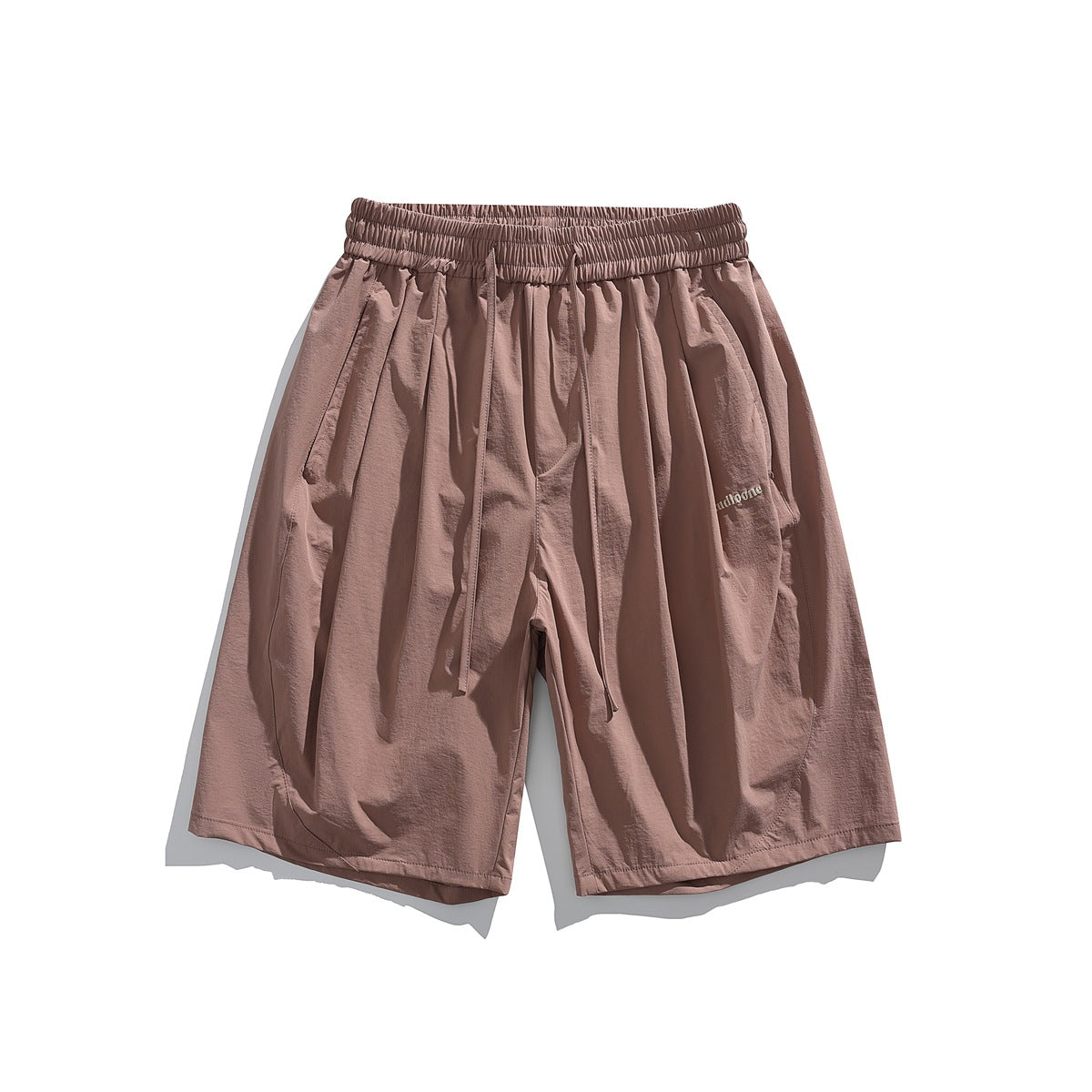 Dusty pink knee-length shorts with elastic drawstring waist, pleated front and small embroidered logo, flat lay front view