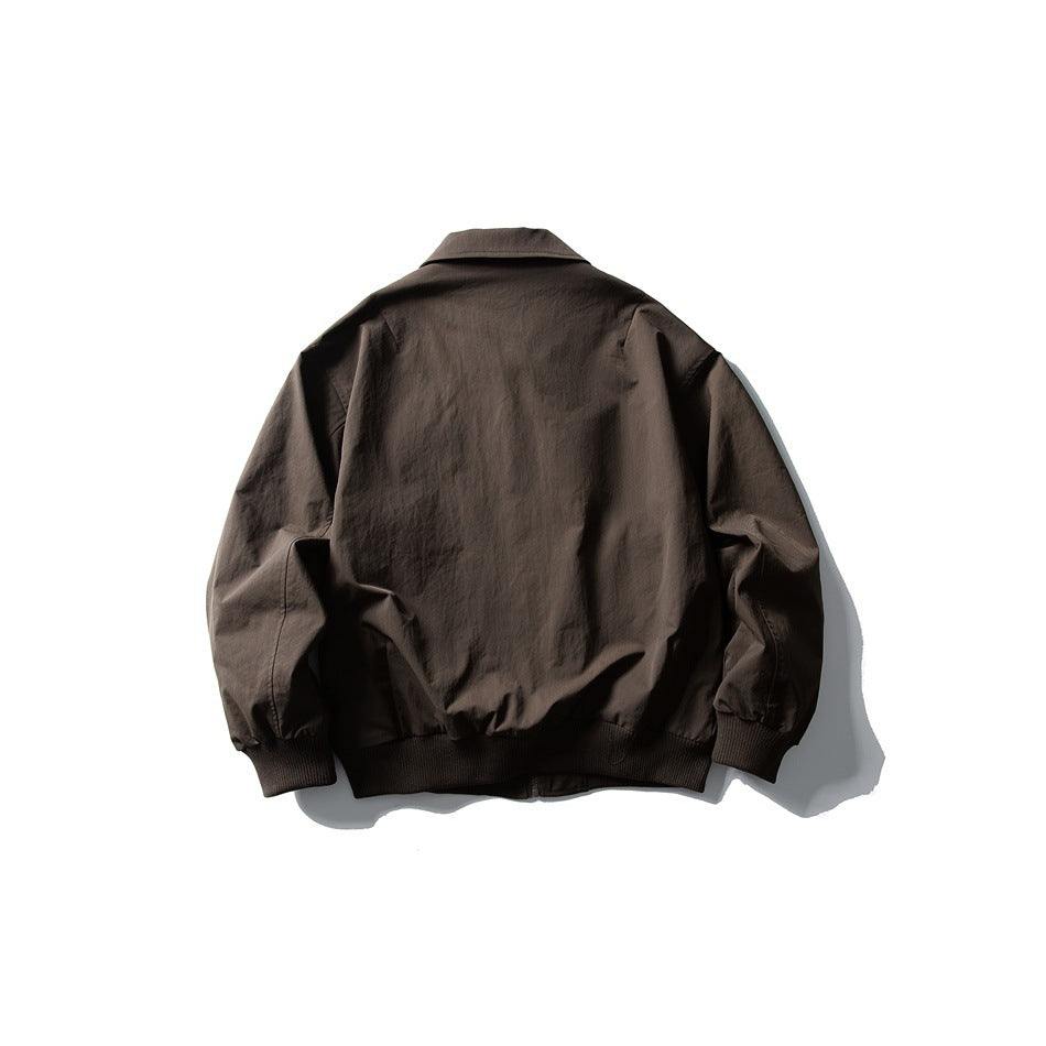 Back view of a dark brown collared jacket with long sleeves and ribbed cuffs and hem.