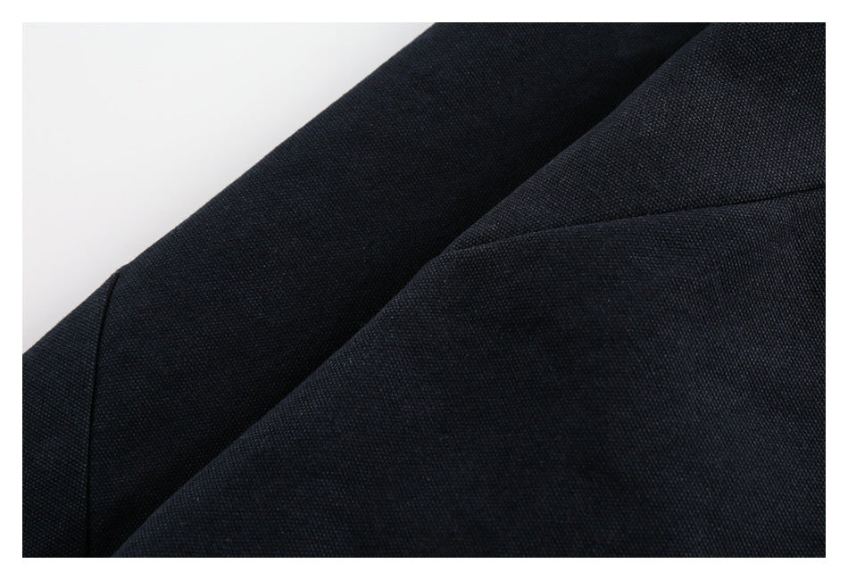 Close-up of overlapping dark navy garment panels and their seams.
