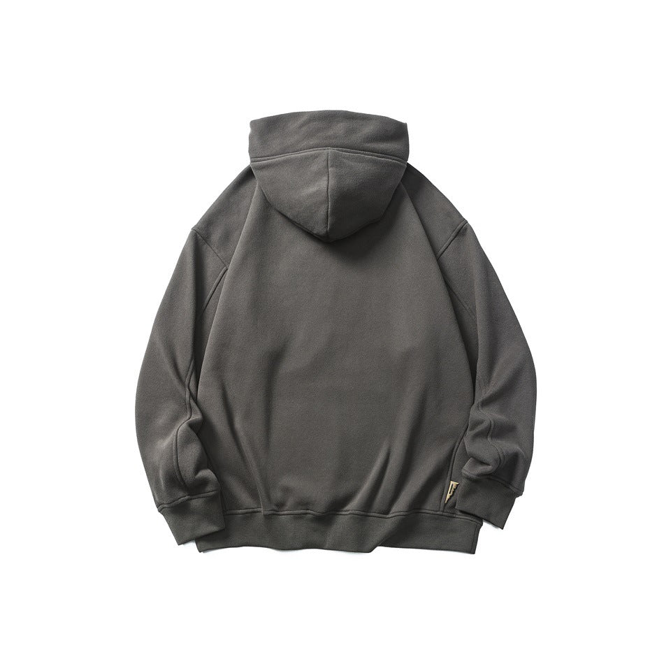Back view of dark gray hoodie flat lay showing hood, ribbed hem and cuffs, and a small side tab