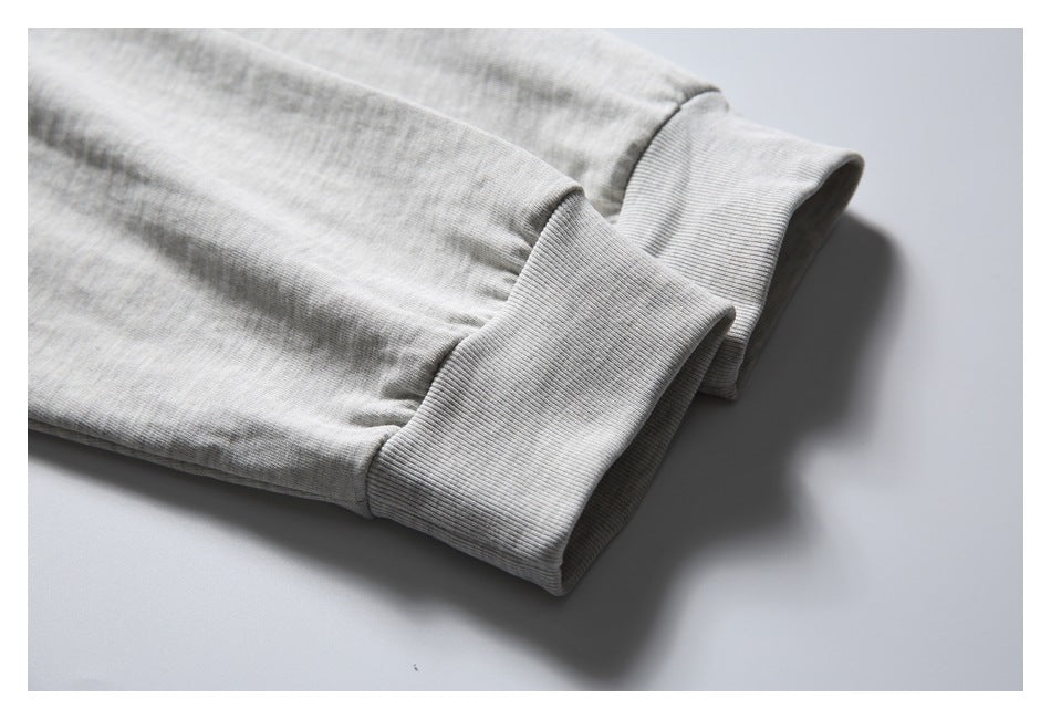 Close-up of the light gray T-shirt's long sleeve and wide ribbed cuff.