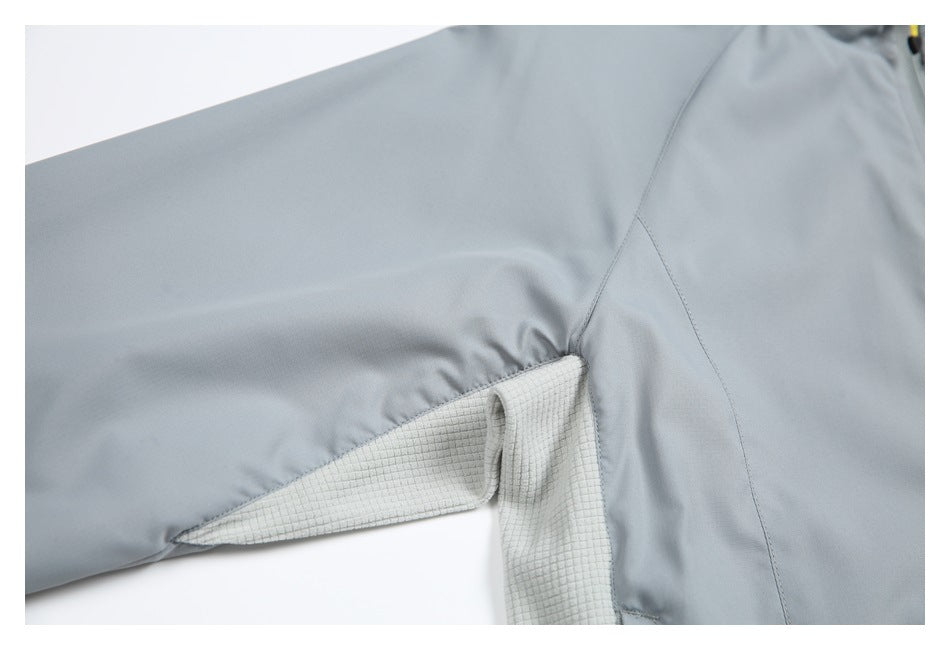 Close-up of the gray jacket's underarm area, showing a light grid-textured gusset.