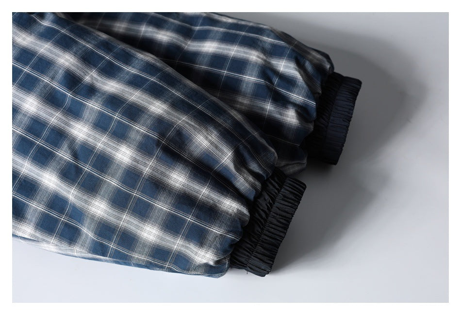 Close-up of a blue-gray plaid sleeve with a black elastic cuff.