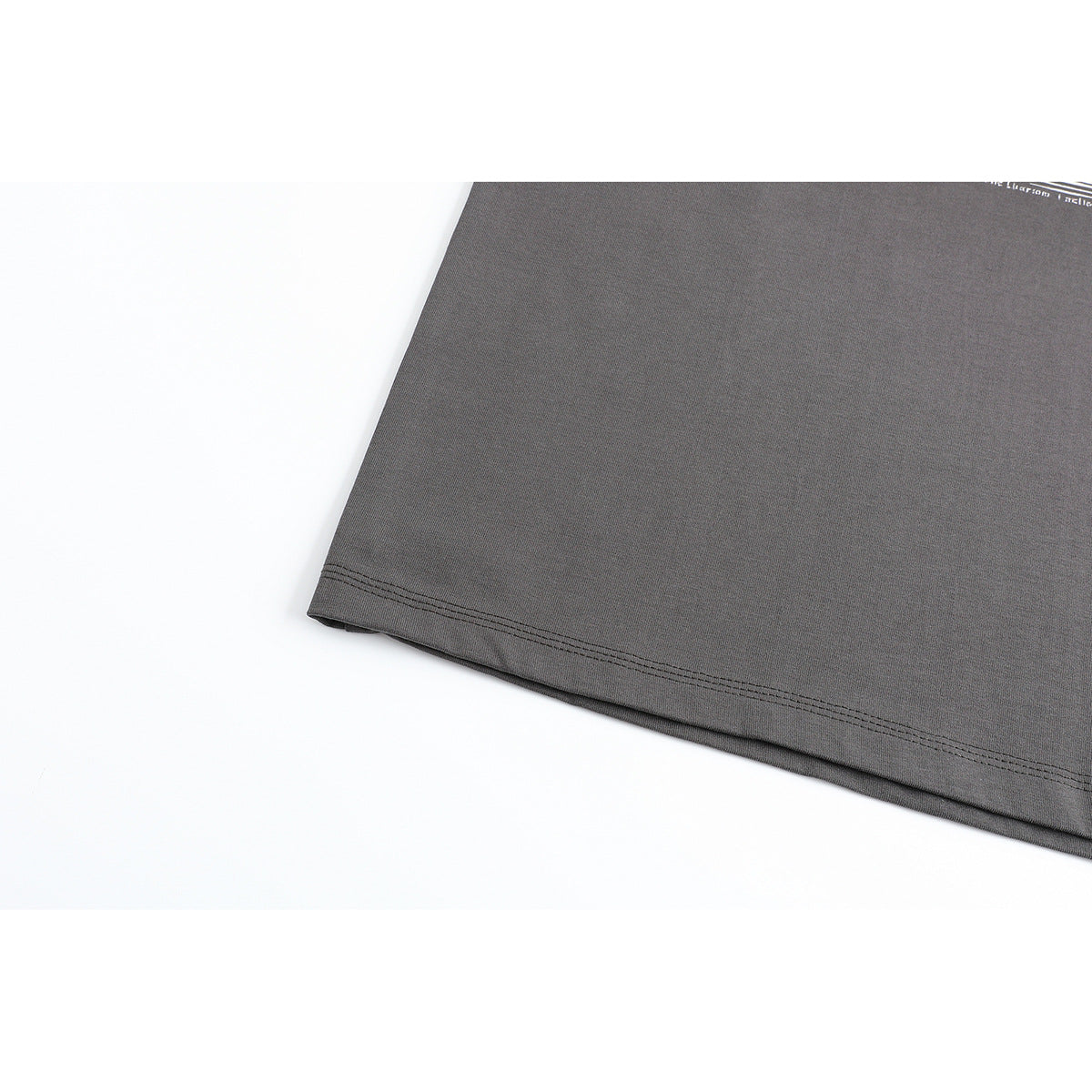 Close-up of the charcoal gray T-shirt's double-stitched bottom hem.