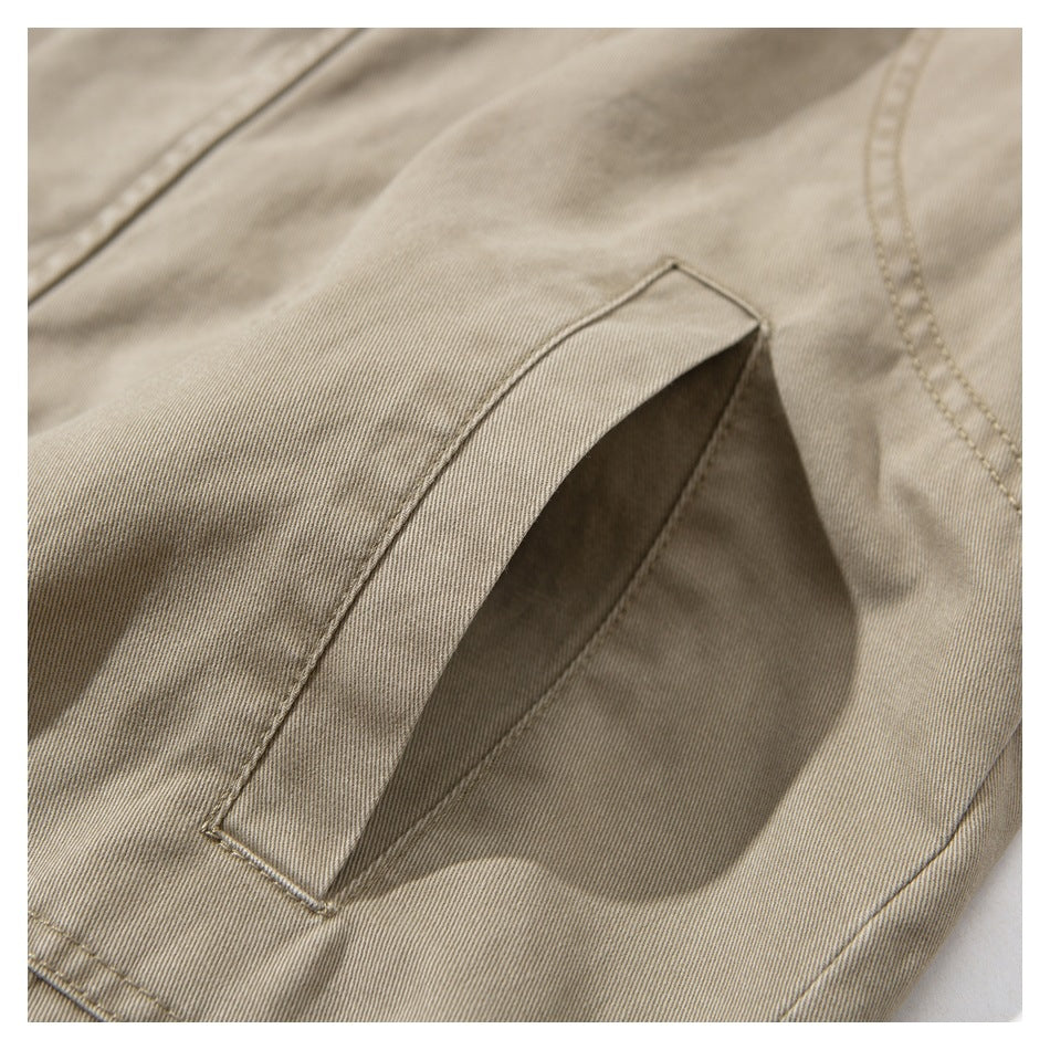 Close-up of a slanted welt pocket on beige fabric, showing its stitching and opening.