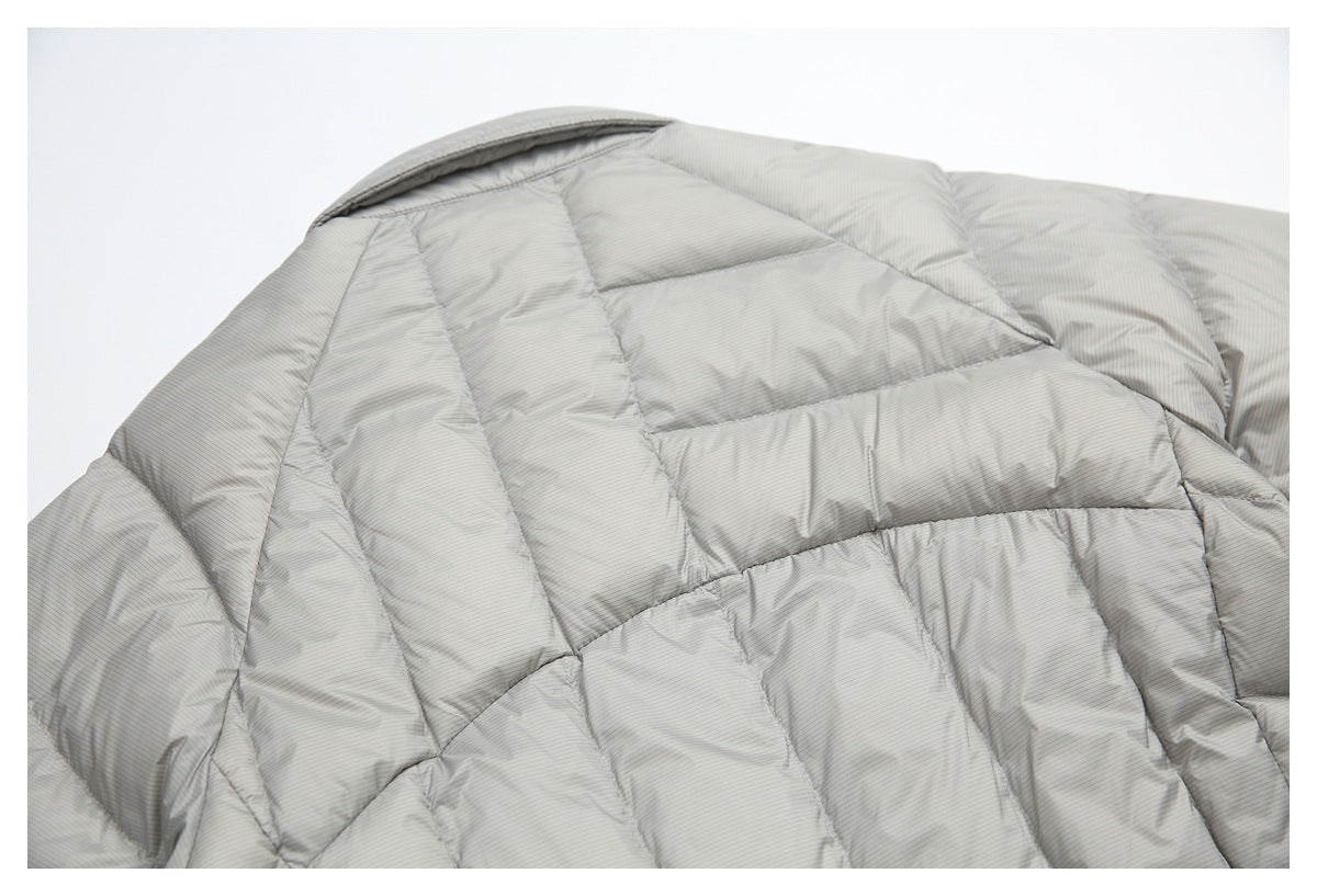 Close-up of the collar and quilted shoulder area of a light gray pinstriped jacket.