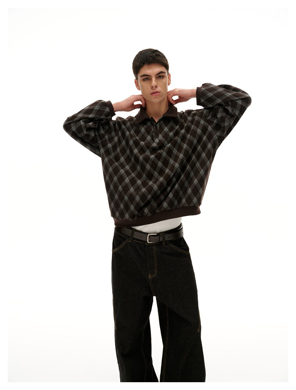 Model wearing a dark brown and charcoal diamond-plaid pullover with a dark collar, cuffs, and hem.