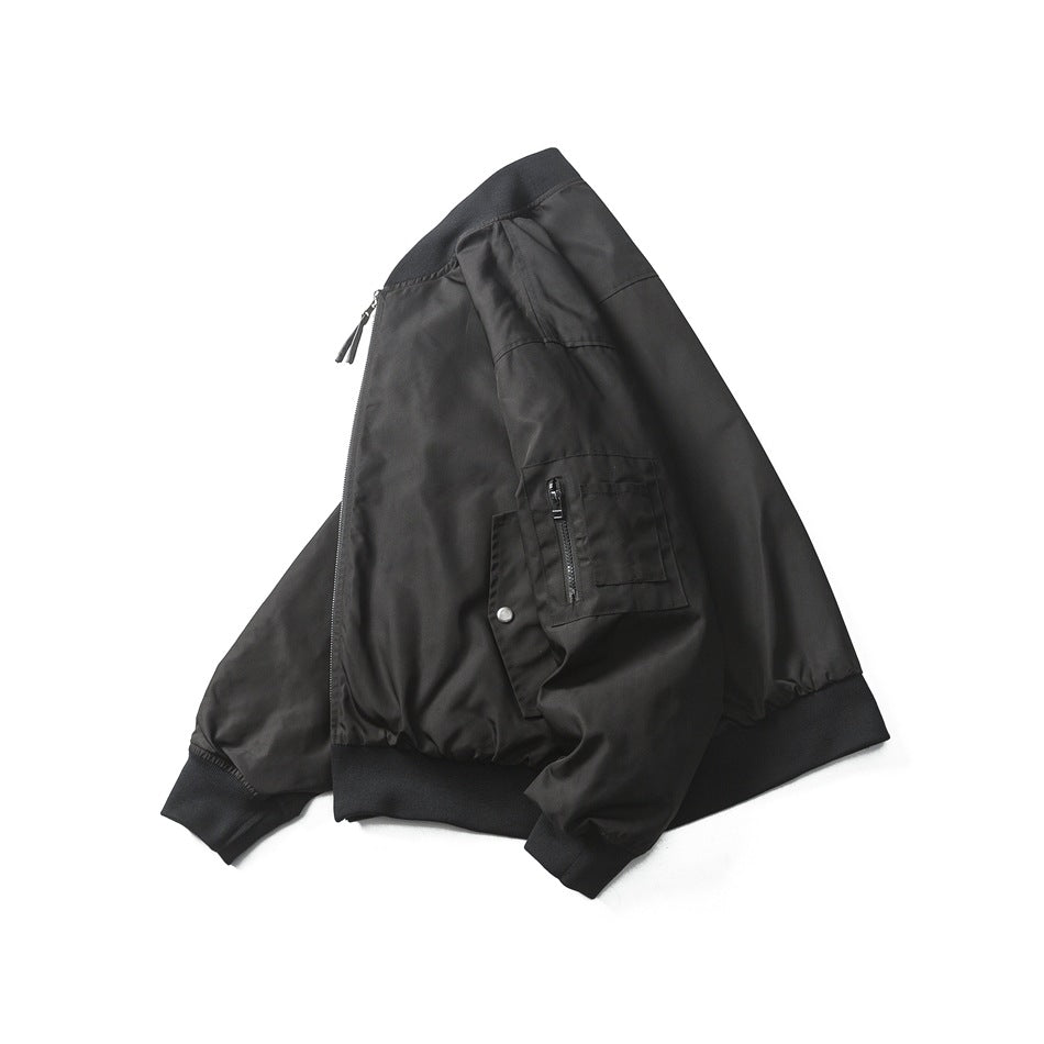 Black bomber jacket arranged on a white background, with a front zipper, ribbed collar, cuffs and hem, and a zippered sleeve