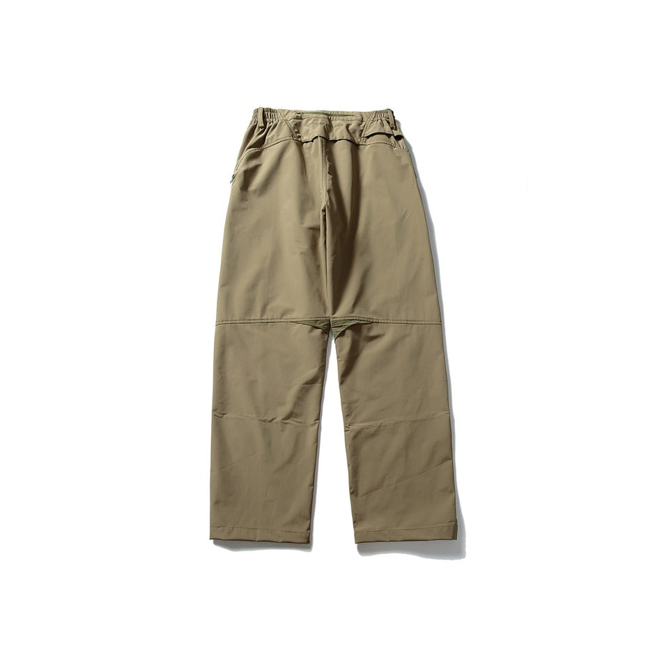 Front view of loose khaki pants with an elastic waist and muted olive gusset accent.