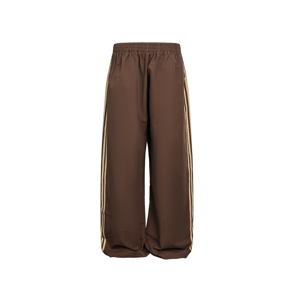 Front view of brown wide-leg pants with an elastic waist and two light contrasting stripes down each side.