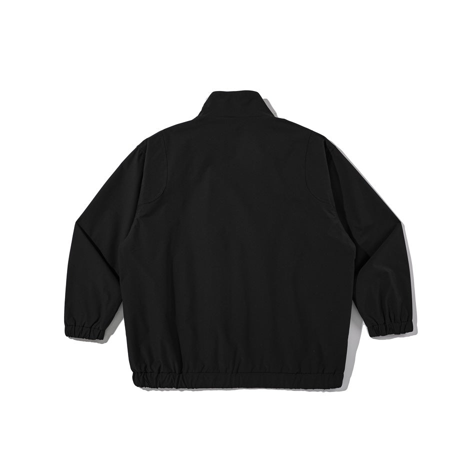 Back view of a black jacket laid flat, with a high collar, long sleeves, and elastic cuffs and hem.