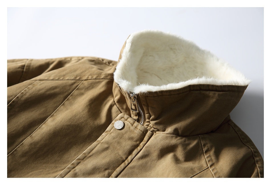 Close-up of the tan jacket's raised collar, showing its plush white lining, zipper, and snap closure.