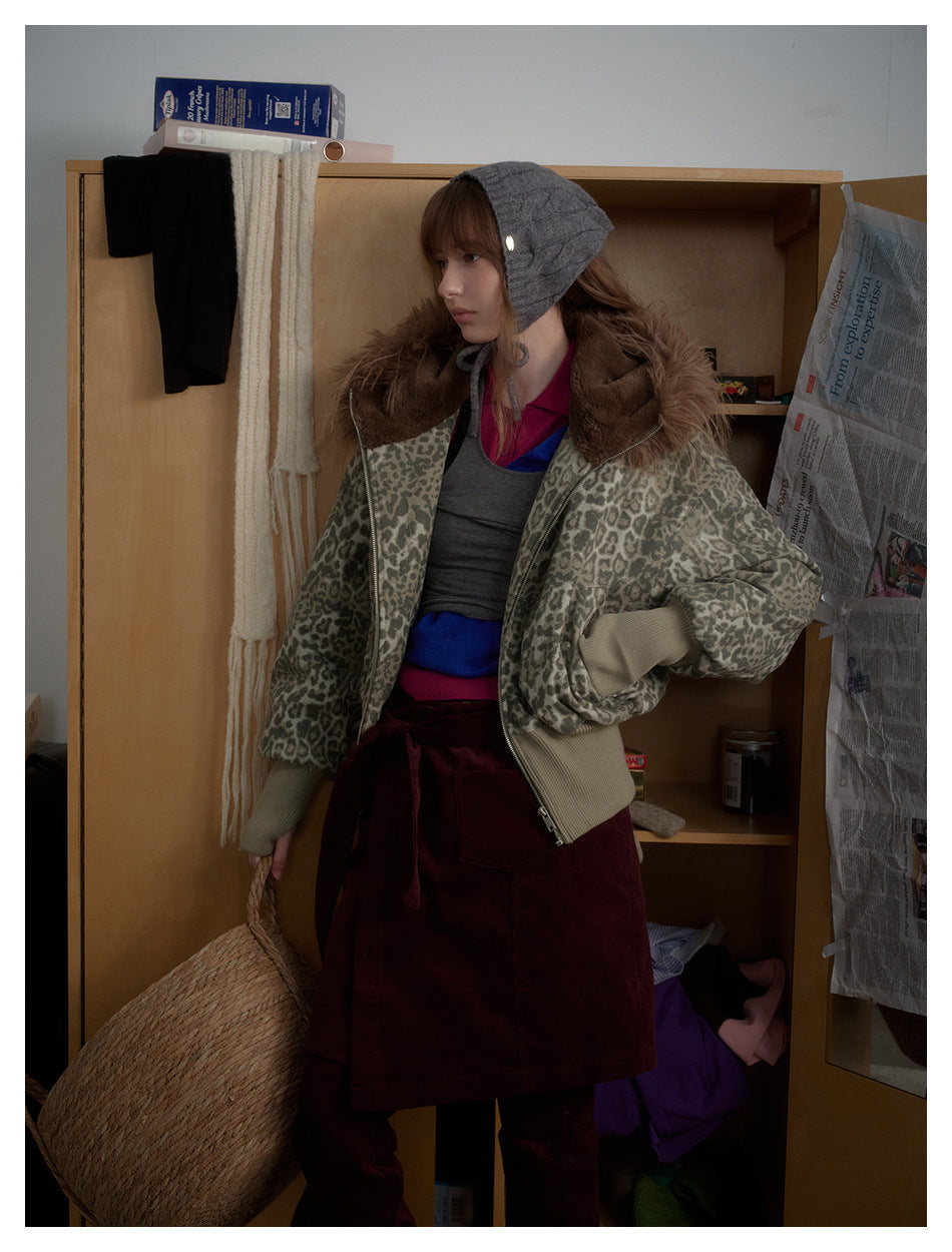 Model wearing a gray leopard-print jacket with a brown fur-trimmed hood, shown at an angle.