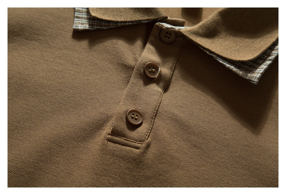 Close-up of a brown polo shirt's three-button placket and collar with plaid lining.