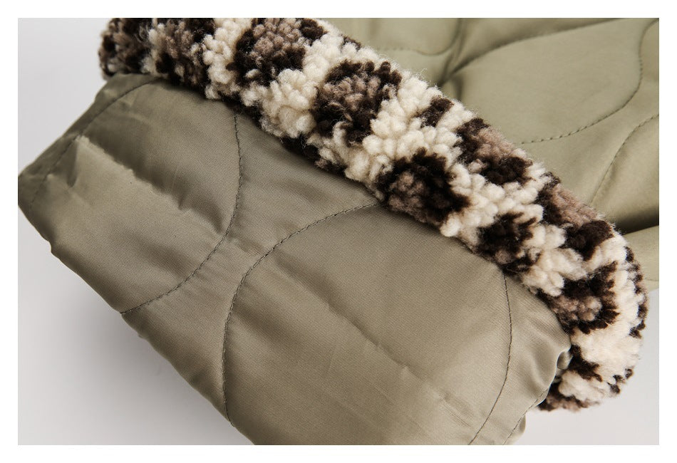 Close-up of a cream-and-dark patterned fleece cuff on olive-khaki quilted trousers.