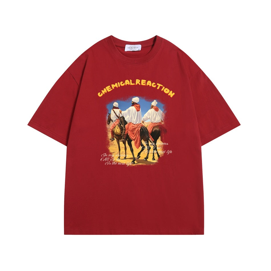 Red short-sleeve crewneck T-shirt with desert riders graphic and yellow CHEMICAL REACTION lettering on the chest