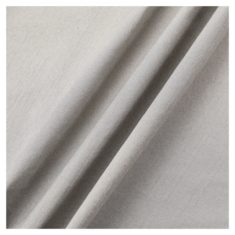 Close-up of the gray trousers' woven-looking surface, shown in soft folds.