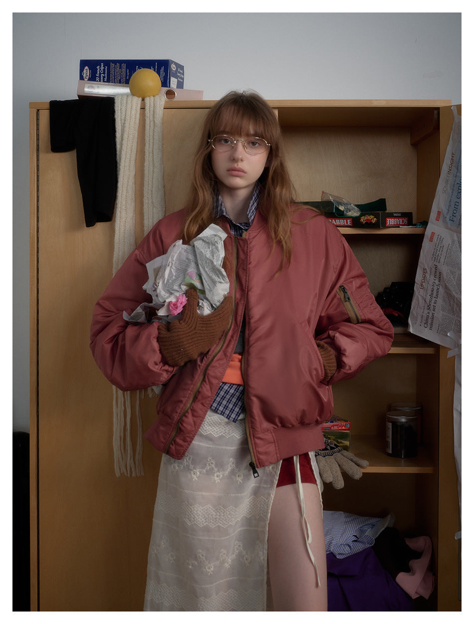 Model wearing a dusty rose bomber jacket with ribbed cuffs and hem, shown from head to mid-thigh.