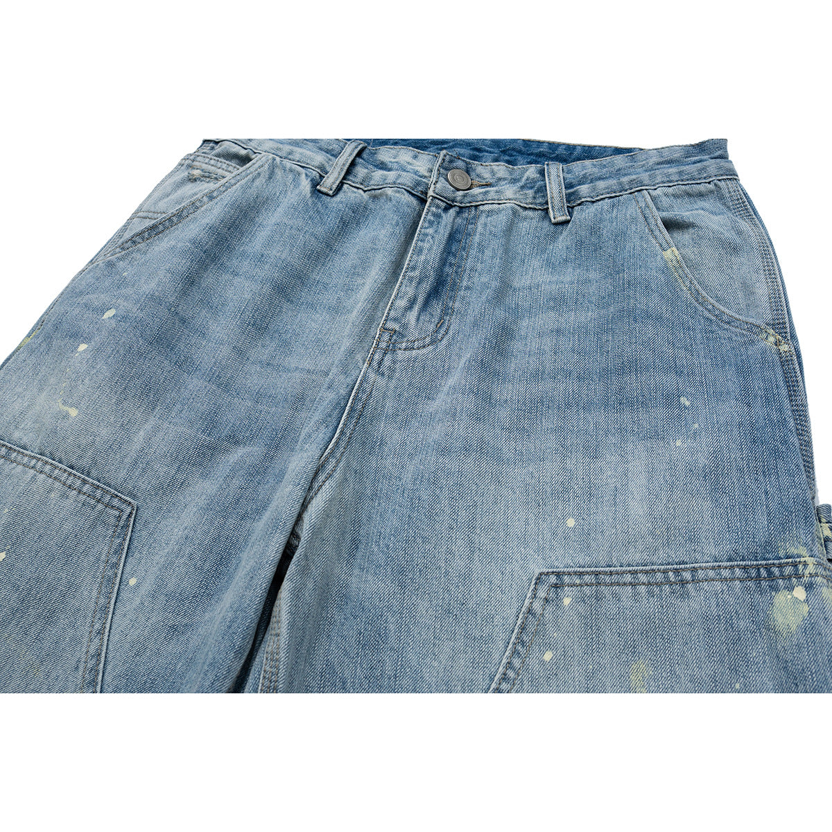 Close-up of light blue distressed jeans showing the waistband, button, front pockets and large utility pockets.