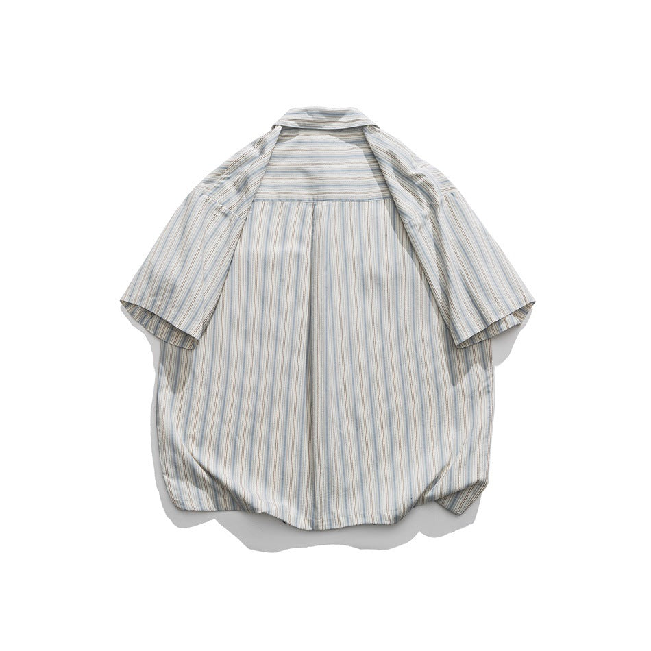 Back of a striped short-sleeve shirt in light blue, beige and white with a horizontal-stripe yoke