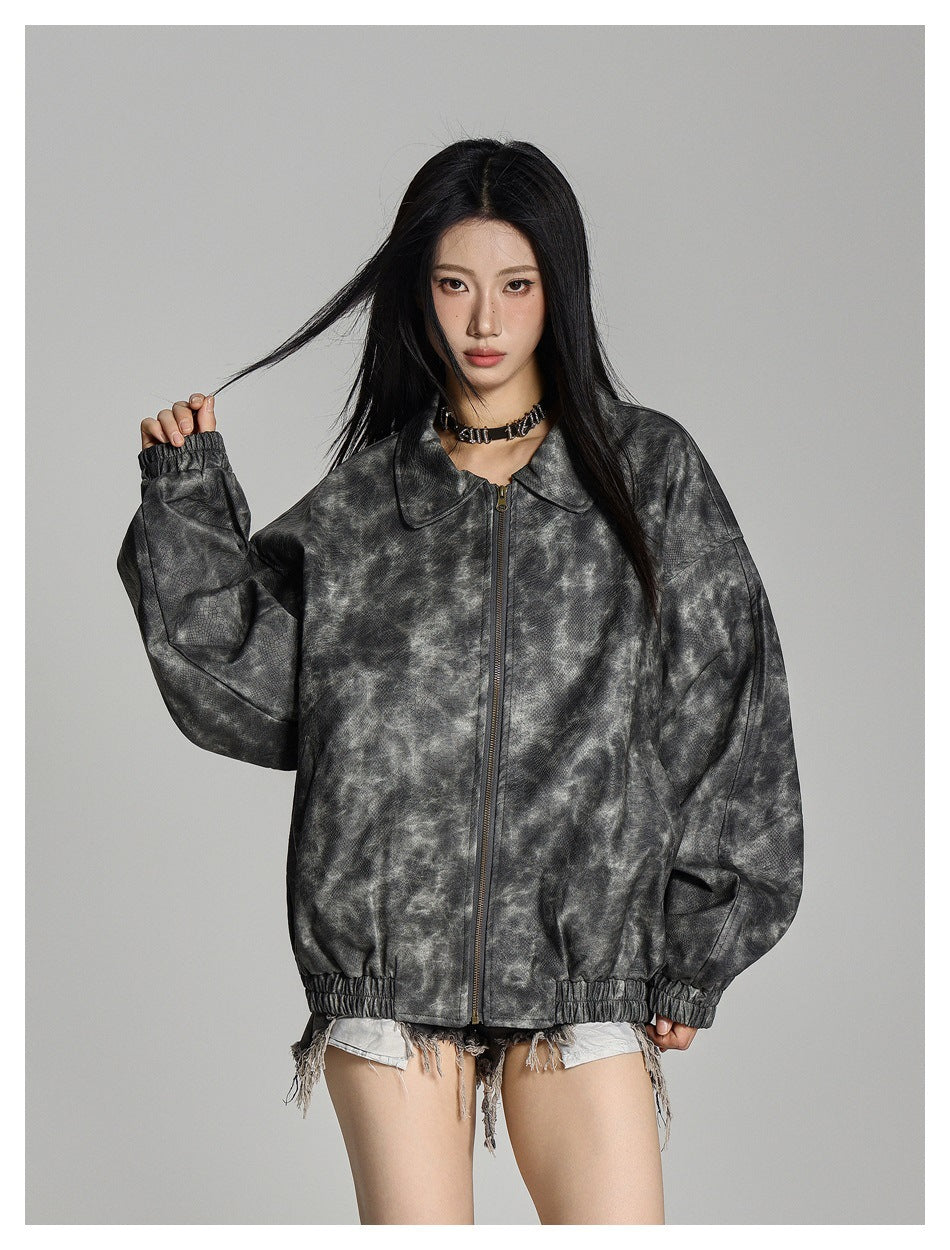 Model wearing a mottled charcoal-gray oversized zip jacket with a wide collar and gathered cuffs and hem.