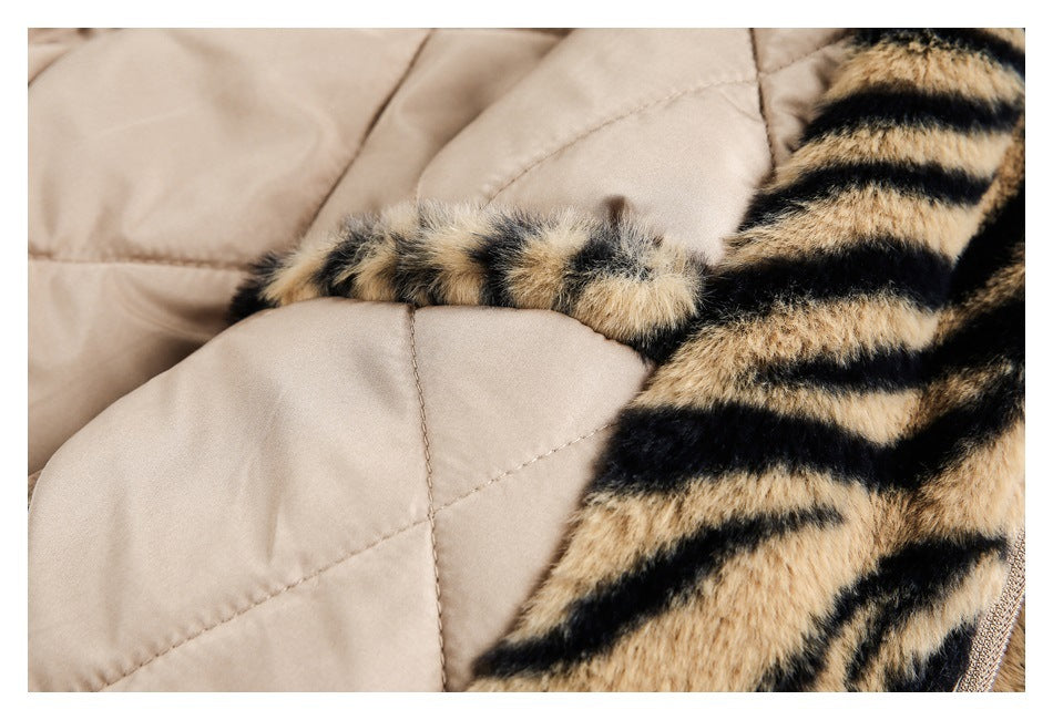 Close-up of beige quilted lining, stitching, and a tan-and-black faux-fur edge.