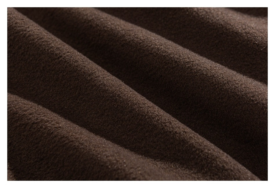 Close-up of dark brown fuzzy fabric draped in soft folds.