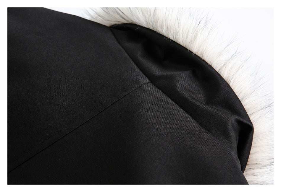 Close-up of a black jacket seam beside a white faux-fur edge.