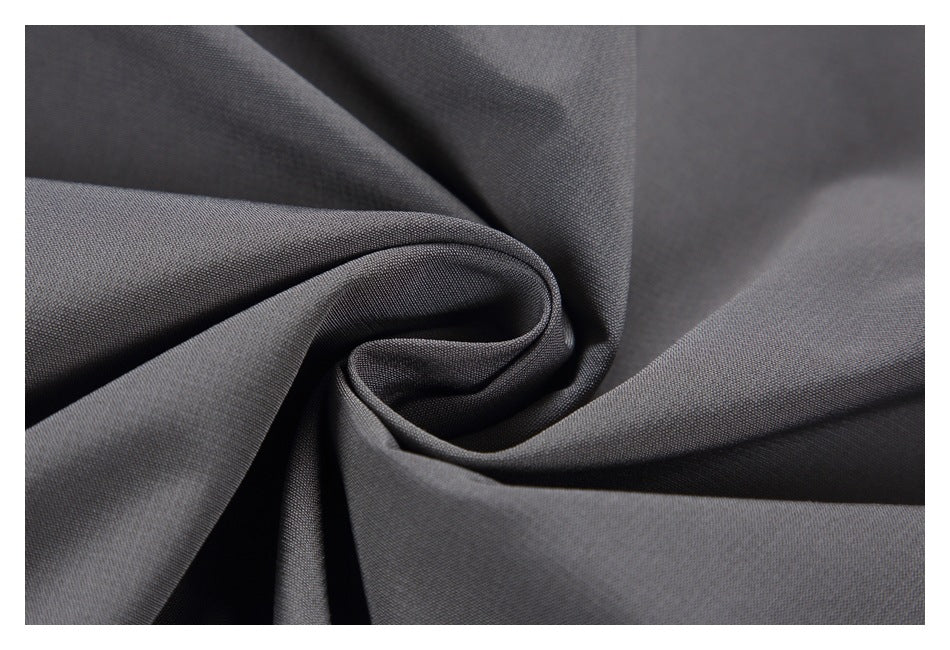 Close-up of dark gray fabric gathered into soft folds.