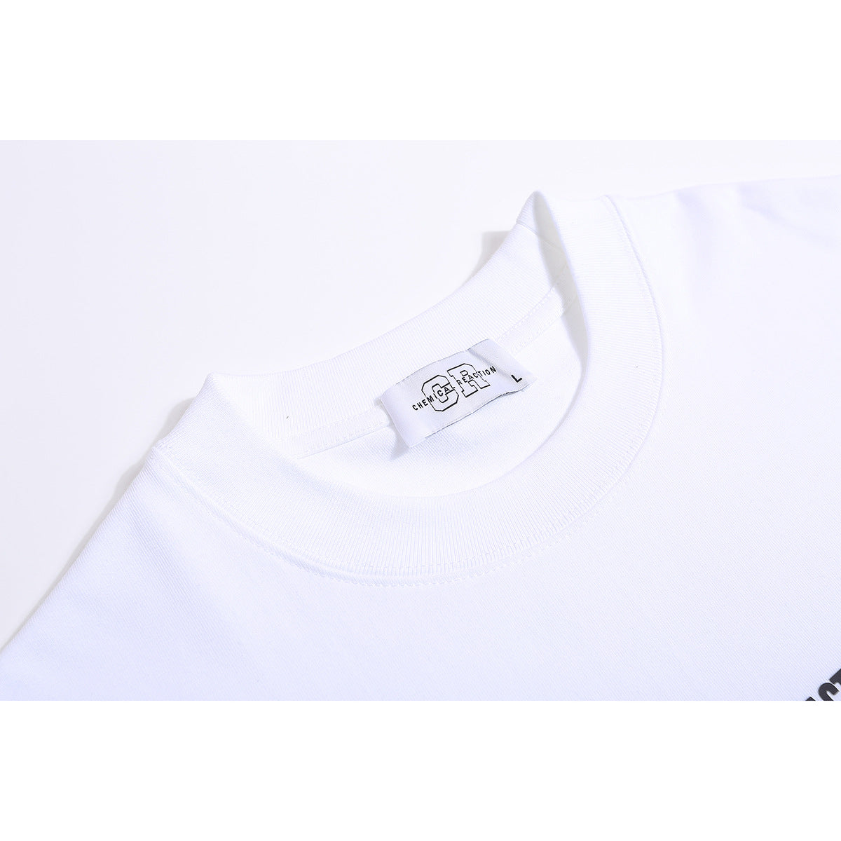 Close-up of a white T-shirt crew neck and inner label reading Chemical Reaction, size L.