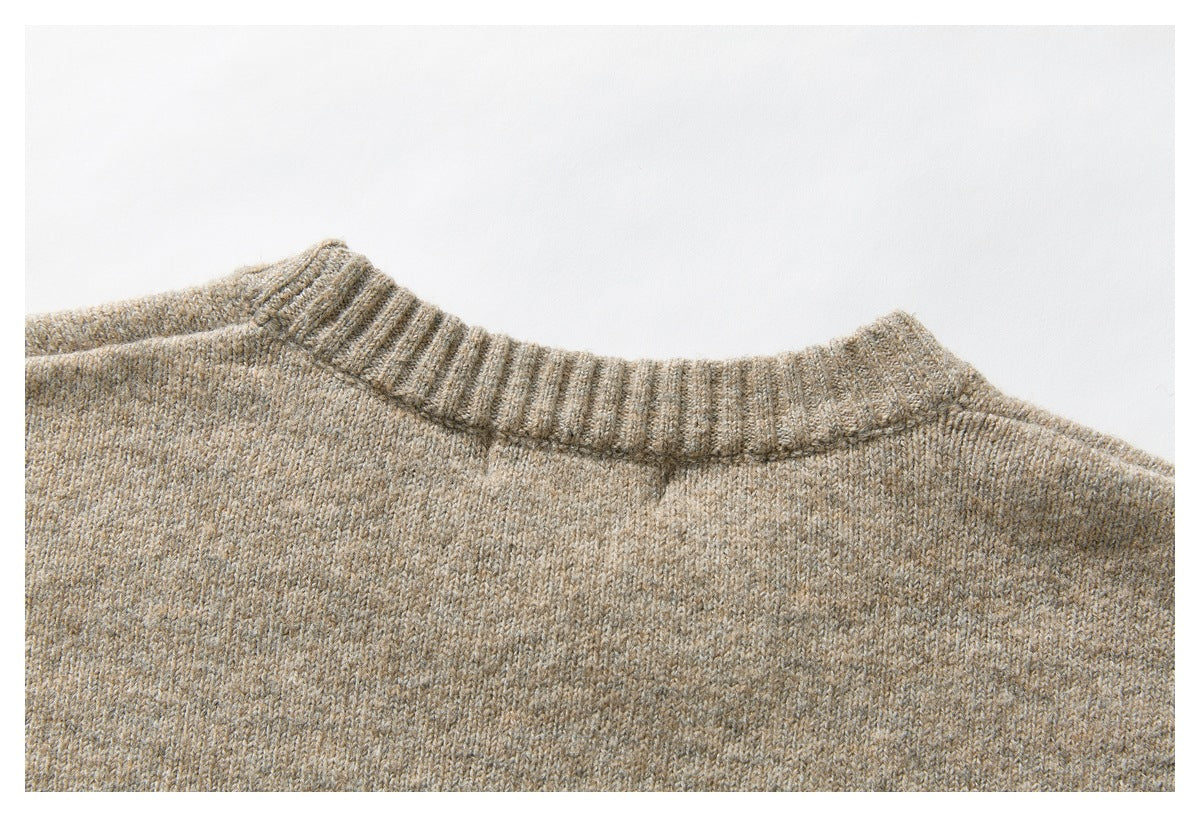 Close-up of the beige sweater’s back neckline and heathered knit.