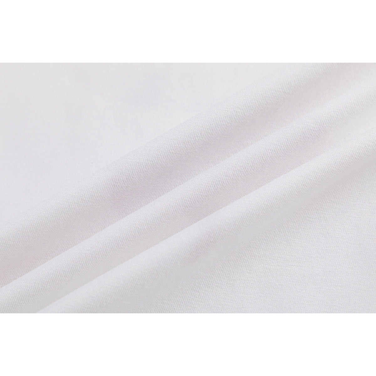 Close-up showing the fine surface texture of white T-shirt fabric.