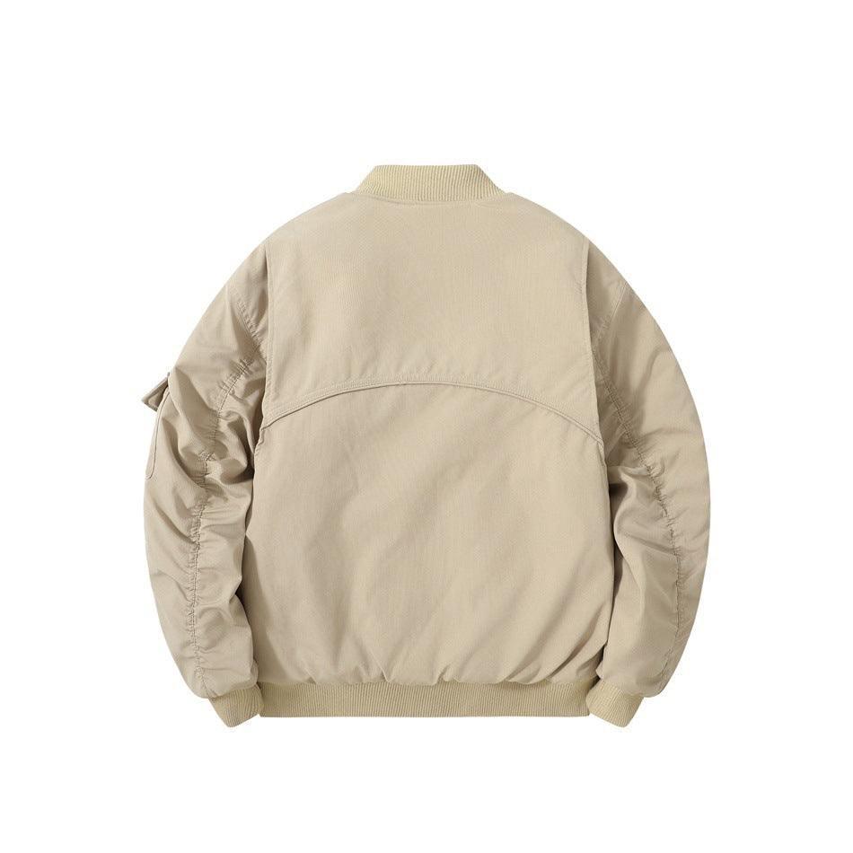 Back view of a beige jacket with a ribbed collar and hem, curved yoke seam, and gathered sleeves.