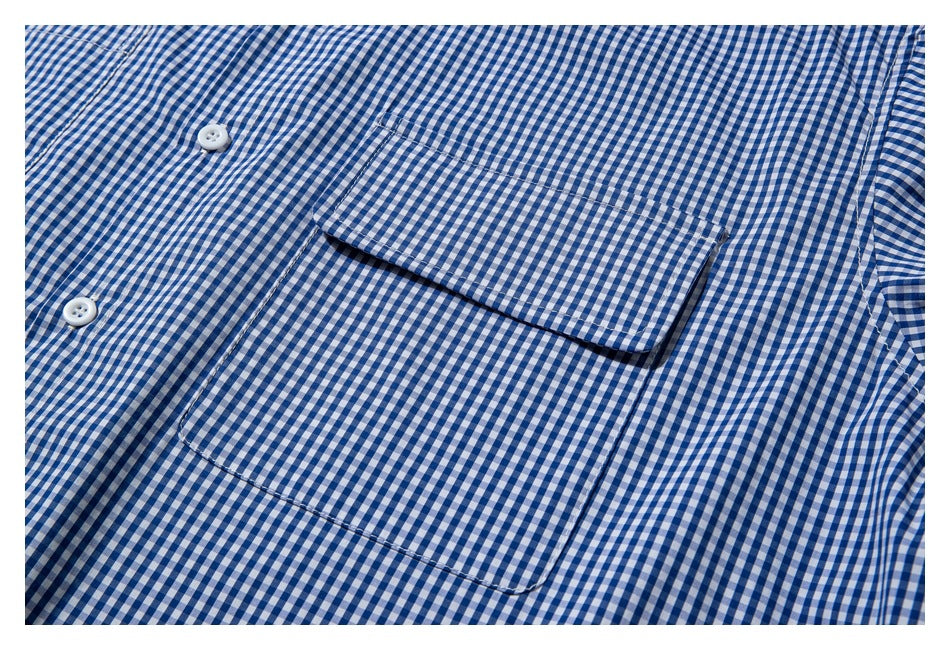 Close-up of a blue-and-white gingham shirt's chest pocket and button placket.