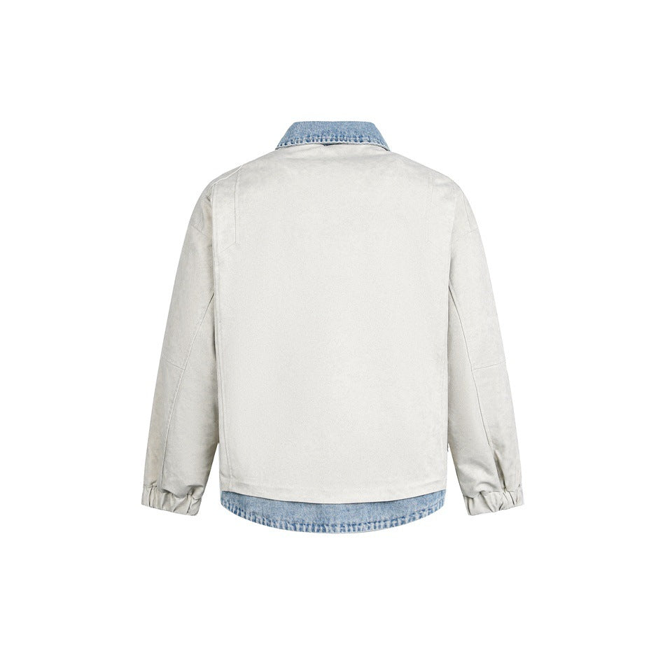 Back view of a light gray jacket with a blue denim collar and curved denim hem.