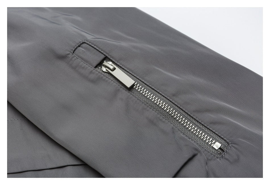 Close-up of a silver metal zipper on dark gray fabric.