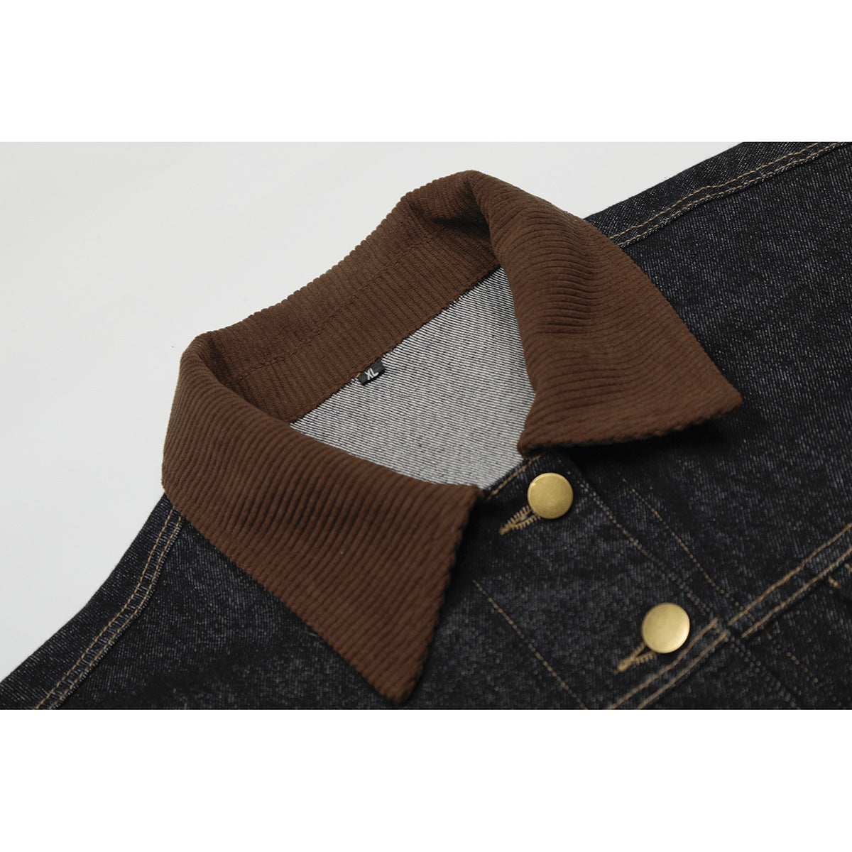 Close-up of a dark denim jacket with a brown ribbed collar, gold-tone buttons, and an inner XL label.